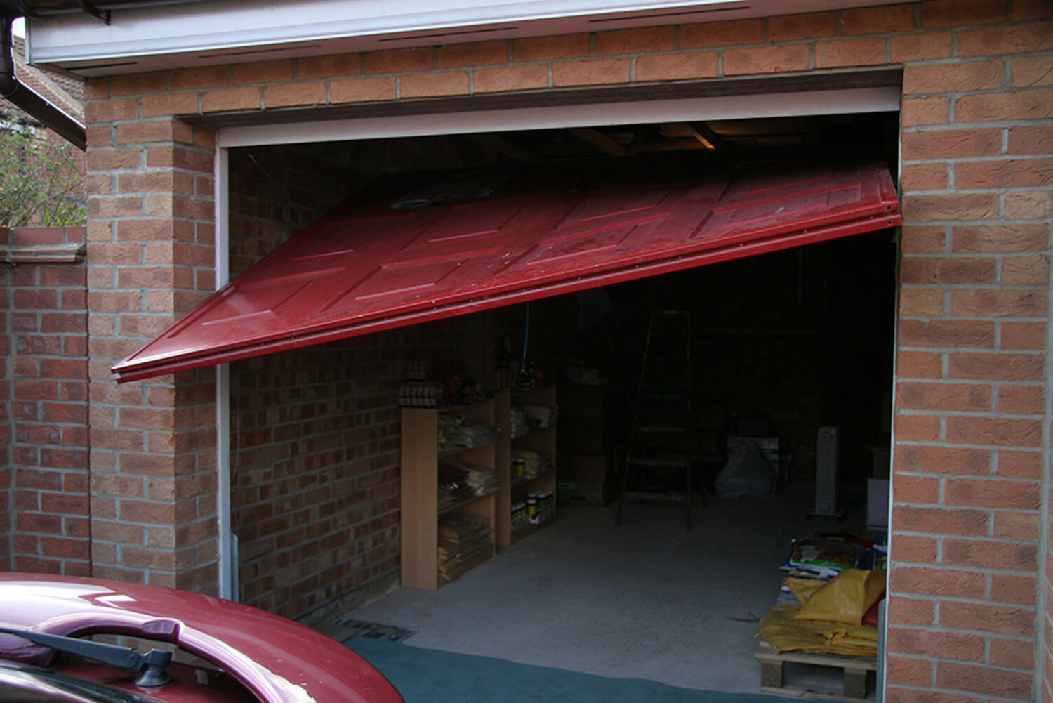 Broken red garage door