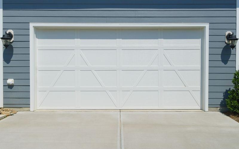 White Garage Door on Grey Home, Two Lights Either Side of Garage Door